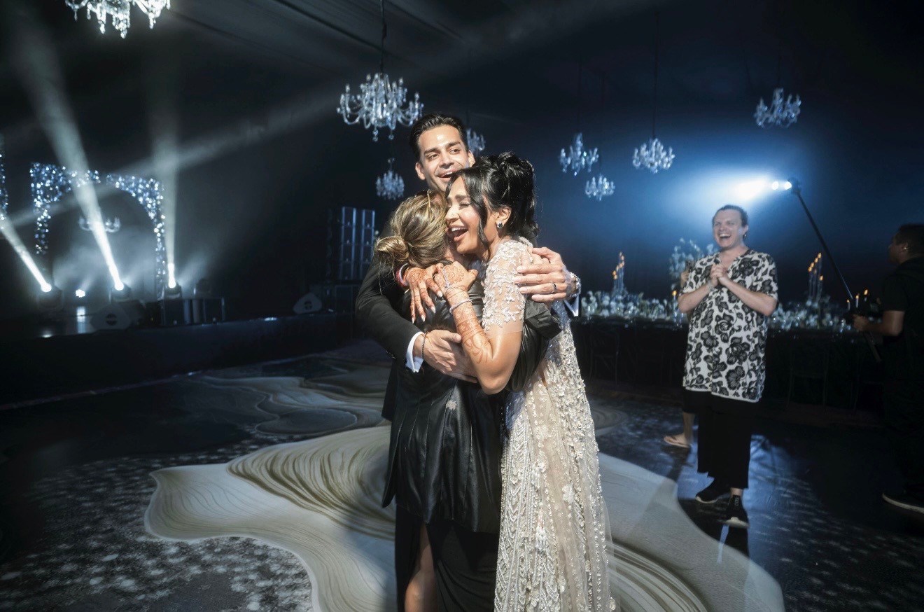 Founder Danielle Lampron hugging and dancing with her wedding clients during the reception, showing deep planner-client connection.
