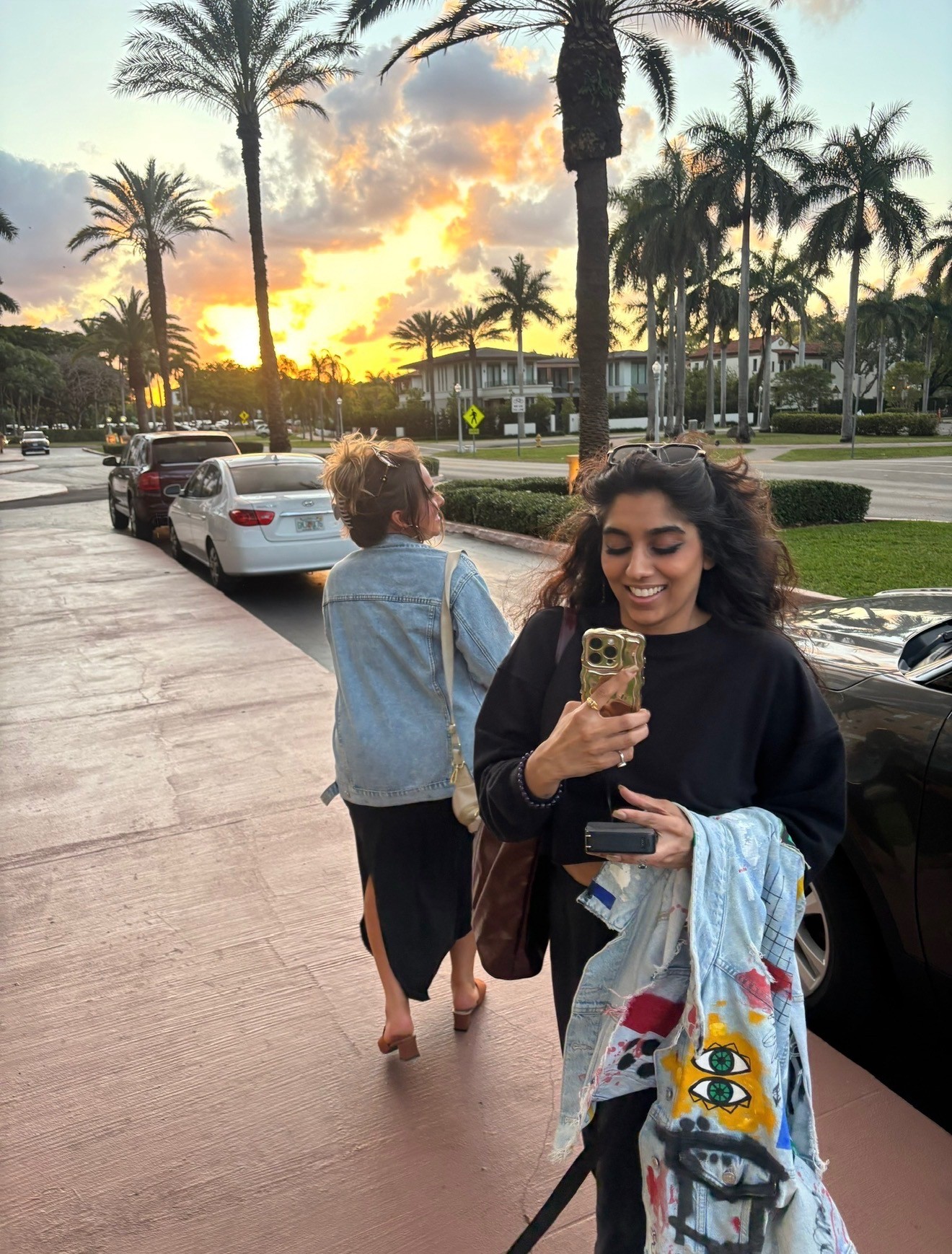Danielle Lampron walking down a sunset street with her clients during a destination wedding weekend.