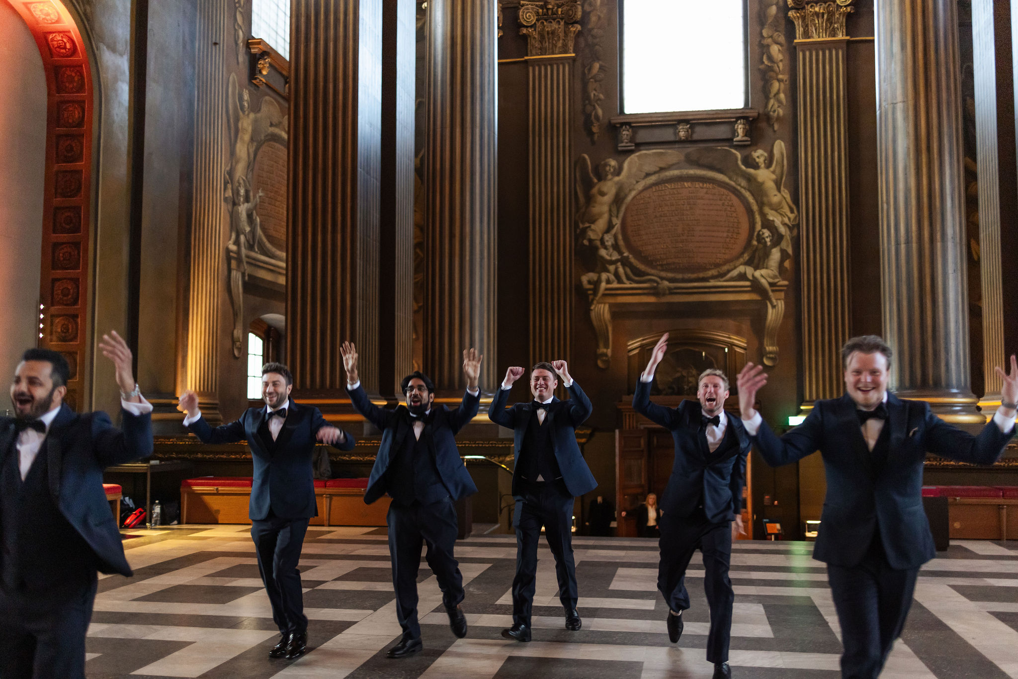 Groomsmen and guests celebrating during a luxury wedding dance floor moment