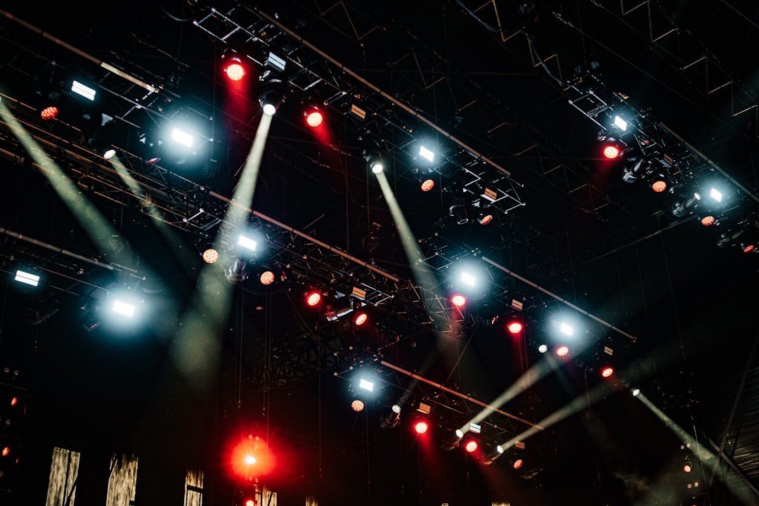 Stage lighting fixtures suspended from an overhead truss