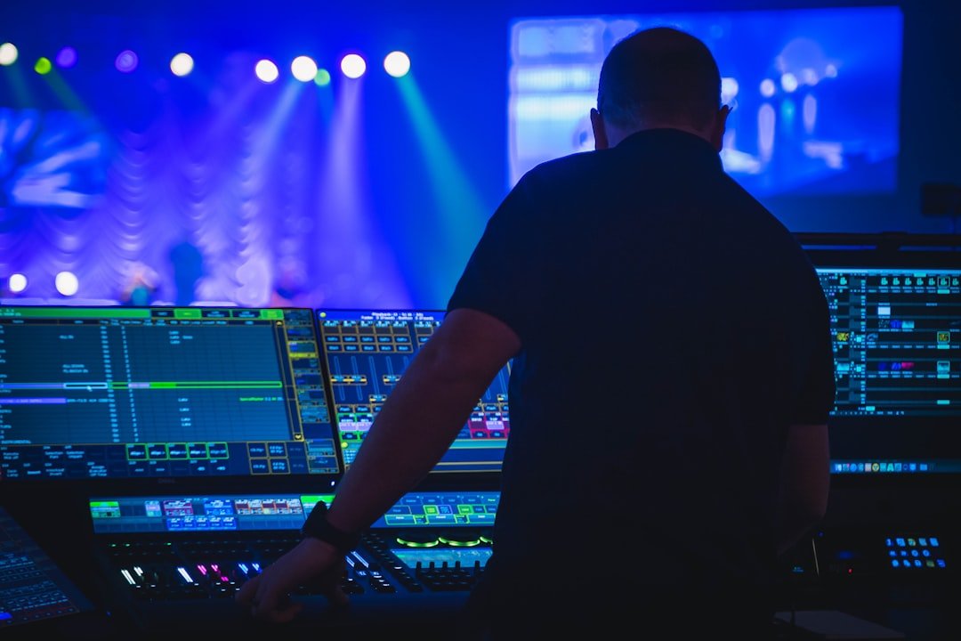Technical operator monitoring sound and lighting during a live event